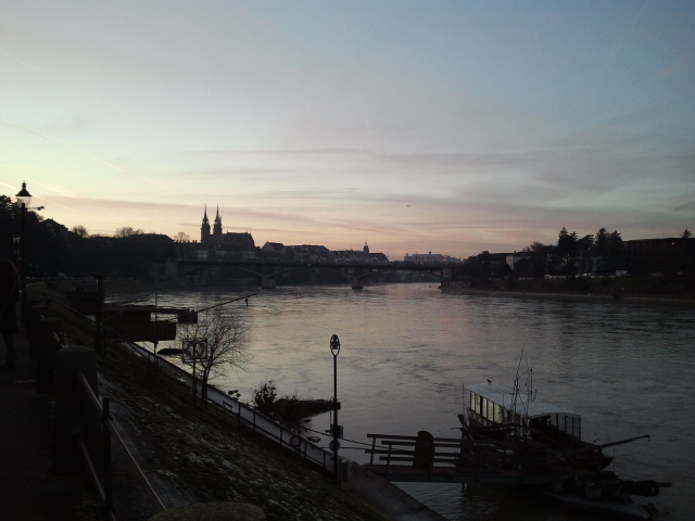 View of the Rhine at sunset, with the two towers of the Munster visible at left.